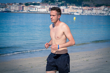 man running on the beach sand