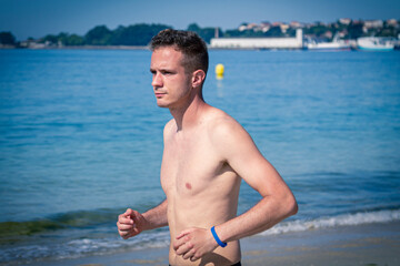 man running on the beach sand