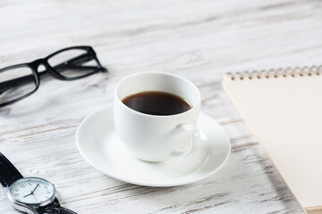 Top view office desk with white cup of coffee