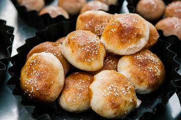 Fresh homemade bread taken from the wood oven. Close up of rustic whole meal bread rolls
