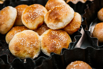 Fresh homemade bread taken from the wood oven. Close up of rustic whole meal bread rolls