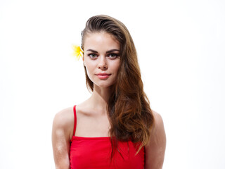 attractive woman with flower in hair and in red t-shirt naked shoulders
