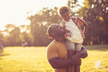 African American father and son in nature.