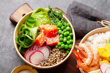 Poke bowls with shrimps, salmon, avocado and mango