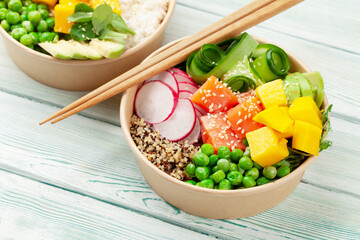 Poke bowls with shrimps, salmon, avocado and mango