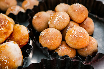 Fresh homemade bread taken from the wood oven. Close up of rustic whole meal bread rolls