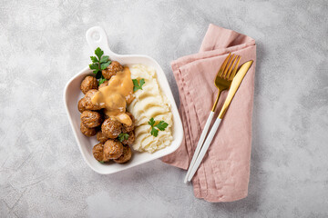  Traditional swedish meatballs with creamy sauce and mashed potatoes on gray background top view