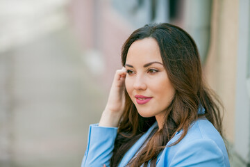 Portrait of a beautiful young woman in a blue suit with a bouquet of tulips. Spring.