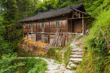 Traditional wooden farm house in  the Longsheng rice terraces in summer, Guangxi Province, China
