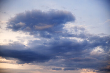 Cumulus clouds in the sky at sunset. Dramatic sky.