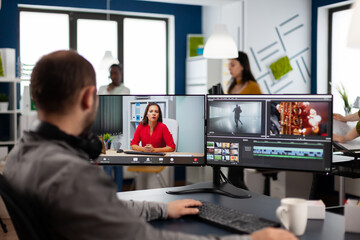 Videographer in web online conference with project manager on video call editing client work,...