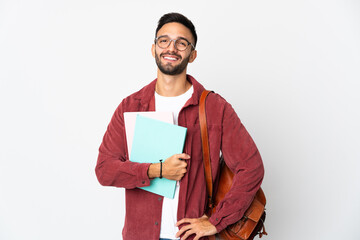 Young student man isolated on white background posing with arms at hip and smiling