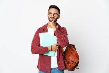 Young student man isolated on white background having doubts and thinking