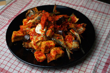Set of Indonesian spicy food consists of salted fish, eggplant, tofu and chili
