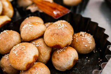 Fresh homemade bread taken from the wood oven. Close up of rustic whole meal bread rolls