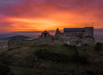 Obraz premium Boldogko, Hungary - Aerial panoramic view of Boldogko Castle (Boldogko vara or Boldogkovaralja) at autumn season with a beautiful colorful golden sunset. The castle can be found in Zemplen Mountains