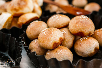 Fresh homemade bread taken from the wood oven. Close up of rustic whole meal bread rolls