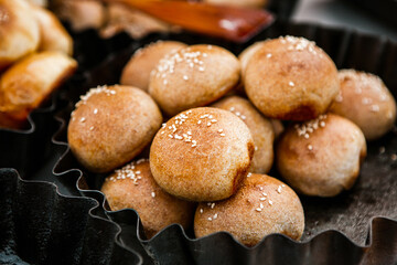 Fresh homemade bread taken from the wood oven. Close up of rustic whole meal bread rolls