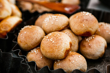 Fresh homemade bread taken from the wood oven. Close up of rustic whole meal bread rolls