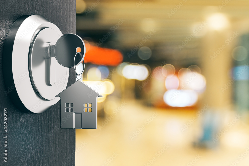 Poster opening door with silver house key chain on blurry office background and mock up place for your adve
