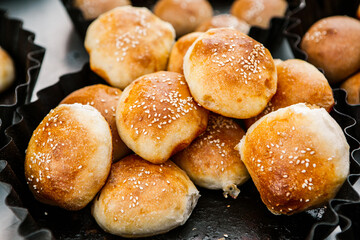 Fresh homemade bread taken from the wood oven. Close up of rustic whole meal bread rolls