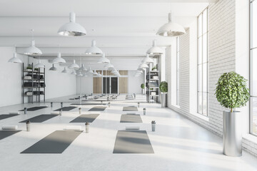 Modern bright white yoga studio gym interior with brick wall, window and city view. 3D Rendering.