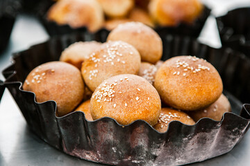 Fresh homemade bread taken from the wood oven. Close up of rustic whole meal bread rolls