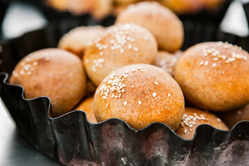 Fresh homemade bread taken from the wood oven. Close up of rustic whole meal bread rolls