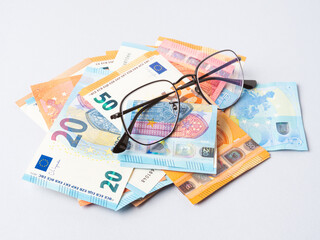 Euro money banknotes and glasses, online banking, business, student loan concept