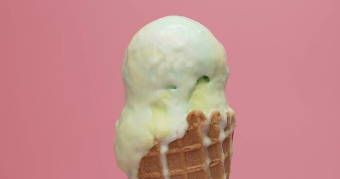 Close up zoom in detail ice cream Rainbow on top ice cream lemon-lime Waffles isolated on the pink background.
