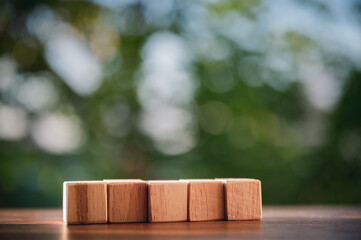 Wood block is arrange row put up on the table show concepts and strategy of business with natural green background.