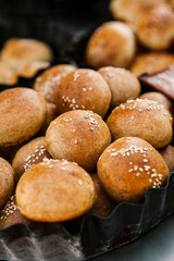 Fresh homemade bread taken from the wood oven. Close up of rustic whole meal bread rolls