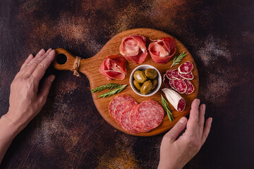 Serving board with a set of different meat snacks.