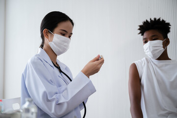 Female doctor or nurse preparing coronavirus 19 vaccination for African-American man waiting to be vaccinated in the laboratory. Concept of preventing the spread of COVID-19.