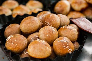 Fresh homemade bread taken from the wood oven. Close up of rustic whole meal bread rolls