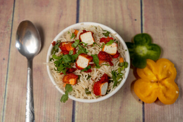 top view of paneer fried rice on a ceramic white bowl