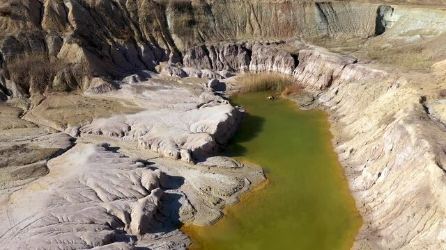  Aerial view of abandoned and flooded open pit gypsum mine, quarry, polluted pond