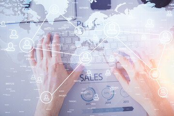 Double exposure of man's hands typing over computer keyboard and social network theme hologram drawing. Top view. People connection web concept.