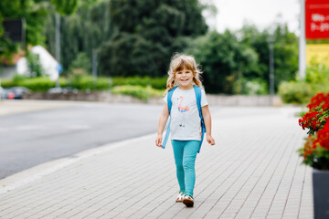 Cute little preschool girl going to playschool. Healthy toddler child walking to nursery and...