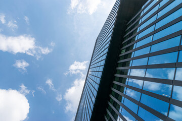 Obraz na płótnie Canvas Business building. Modern office business building with glass, steel facade exterior. Finance corporate architecture city in abstract blue sky with nature cloud in sunny day.