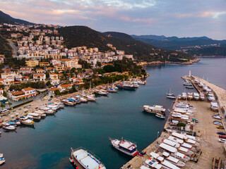 View from drone of small Turkish town of Kas on Turquoise Coast of Aegean Sea overlooking embankment and marina