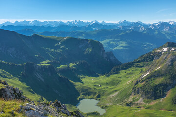 Fototapeta na wymiar Landscape view of the swiss Alps, with blue sky in the background, shot from the 
