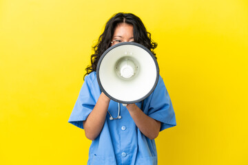 Young surgeon doctor asian woman isolated on yellow background shouting through a megaphone