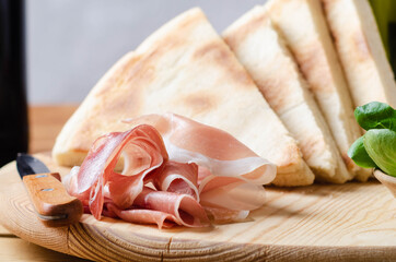 Torta al testo, flatbread with ham prosciutto crudo - traditional umbrian Italy streetfood.