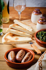 Torta al testo, flatbread with spinach and grilled sausage - traditional umbrian Italy streetfood.