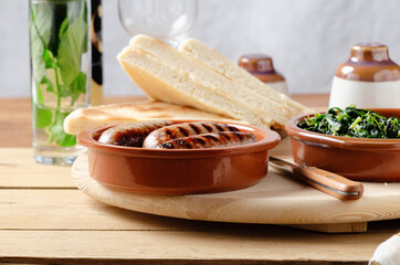 Torta al testo, flatbread with spinach and grilled sausage - traditional umbrian Italy streetfood.