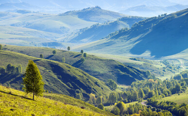 Fototapeta premium Mountain valley on a summer morning, green hills