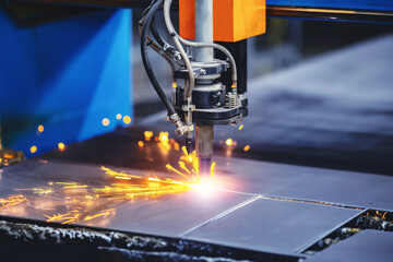 Plasma cutting CNC machine cuts metal material with sparks, industry background