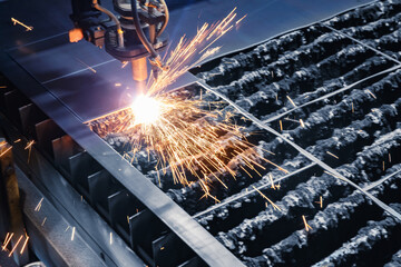 Closeup plasma cutting CNC machine cuts metal material with sparks. Concept industry background,...