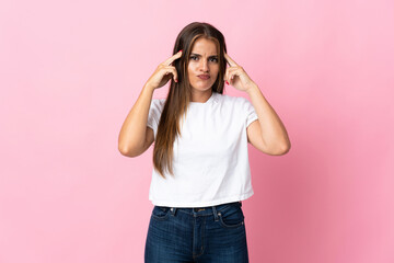 Young Uruguayan woman isolated on pink background having doubts and thinking
